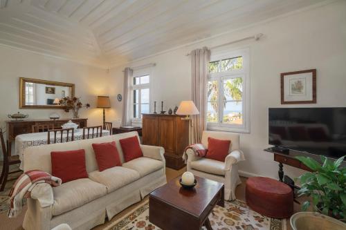 a living room with a couch and a tv at Casa dos Terços by An Island Apart in São Vicente