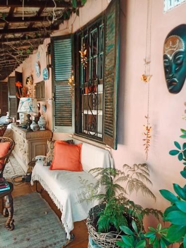 a room with a couch and a window and plants at Vila Santa Rosa Guest House in Ilhabela