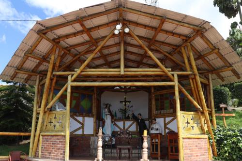 a church with a wooden roof with people inside at Chalet en la montaña in Cogua