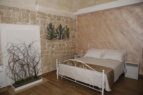 1 dormitorio con cama y pared de ladrillo en Nel Vicoletto, en Cassano delle Murge
