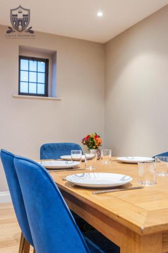 a large wooden table with blue chairs and a tableastery at Castle Properties:Eton-The College in Windsor