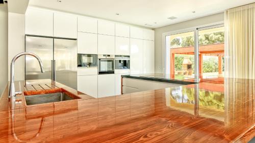 a kitchen with white cabinets and a black counter top at Dream Villa with Luxury Services - PROMOTION Last dates! in Vilamoura