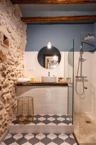 a bathroom with a sink and a mirror at El Palauet del Priorat in Cornudella