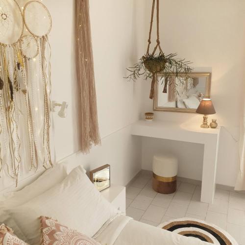 a living room with a couch and a mirror at Sagma Central Rooms in Perissa