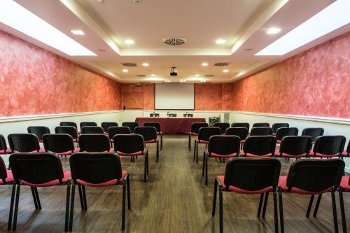 a conference room with chairs and a podium at L'Antico Uliveto in Porto Potenza Picena