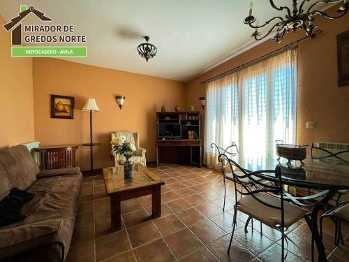 a living room with a couch and a table at Casa el Mirador de Gredos Norte in Hoyocasero