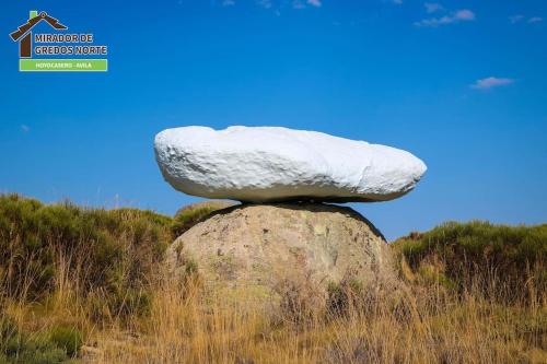 a stone on top of a rock on a hill at Casa el Mirador de Gredos Norte in Hoyocasero