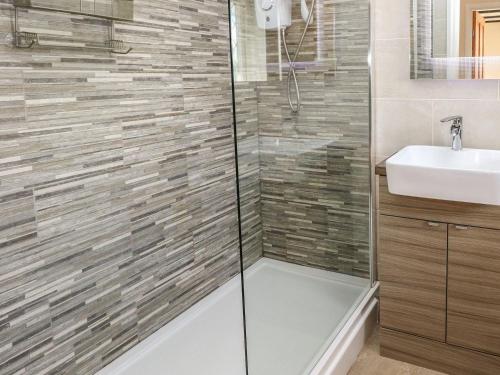 a bathroom with a shower and a sink at The Smithy in Tenby