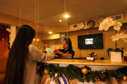 a woman is standing at a counter in a store at Sandals Inn in Daytona Beach