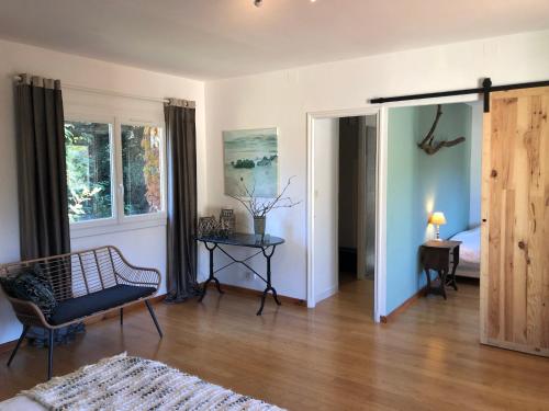 a living room with a chair and a table at Villa Bonheur Vallespir in Céret