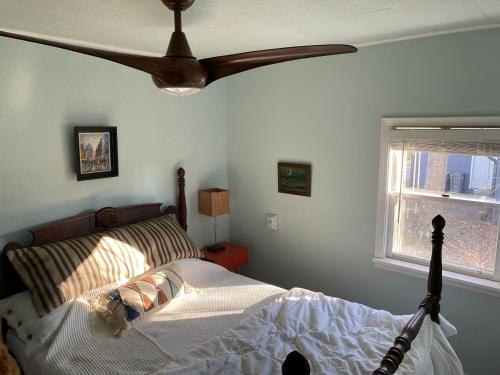 a bedroom with a bed with a ceiling fan at Boho-Chic Travel Pad - Unit 2 in Bloomington