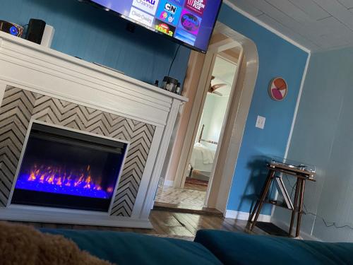 a fireplace in a living room with a fire place at Boho-Chic Travel Pad - Unit 2 in Bloomington