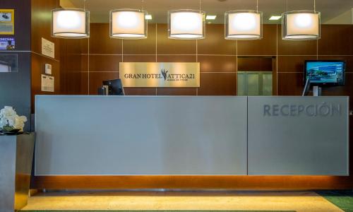 a reception desk in a lobby with lights at Gran Hotel Attica21 Las Rozas in Las Rozas de Madrid