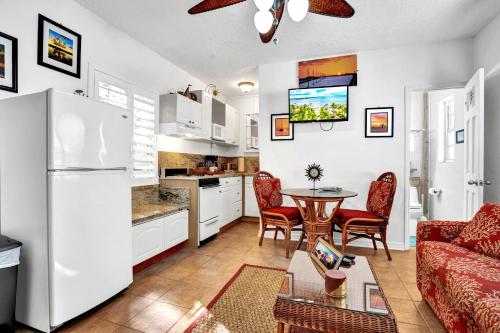 a living room filled with furniture and a kitchen at Island Bay Resort in Key Largo
