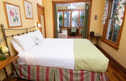 a bedroom with a large white bed in a room at Sweetwater Branch Inn in Gainesville