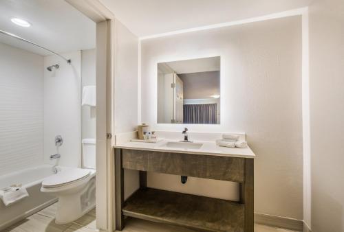 a bathroom with a sink and a toilet at Days Inn by Wyndham Chula Vista-San Diego in Chula Vista
