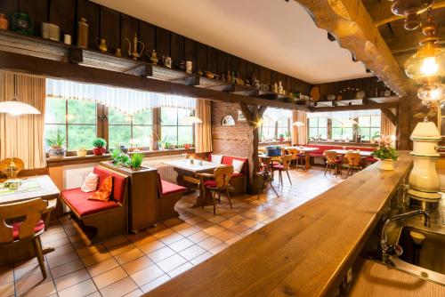 a restaurant with tables and chairs and a bar at Gästezimmer 5 im Landgasthaus Lindenhof in Fresenburg