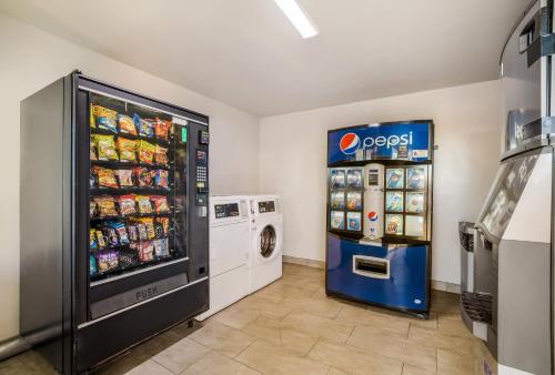a soda machine and a pepsi refrigerator in a store at Days Inn by Wyndham Chula Vista-San Diego in Chula Vista