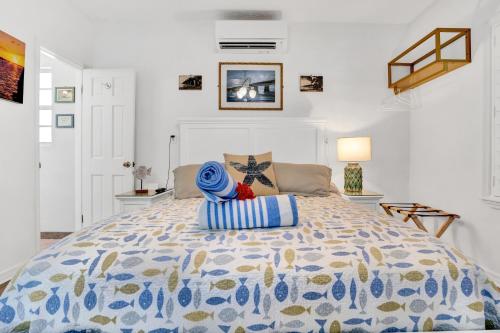 a bedroom with a bed, table, and a painting on the wall at Island Bay Resort in Key Largo
