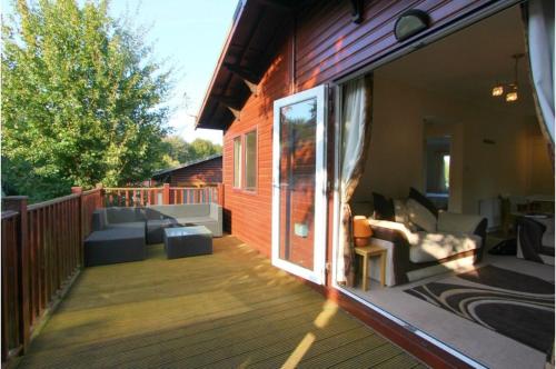 a screened in porch of a house with a patio at Brambles Holiday Lodges in Paignton