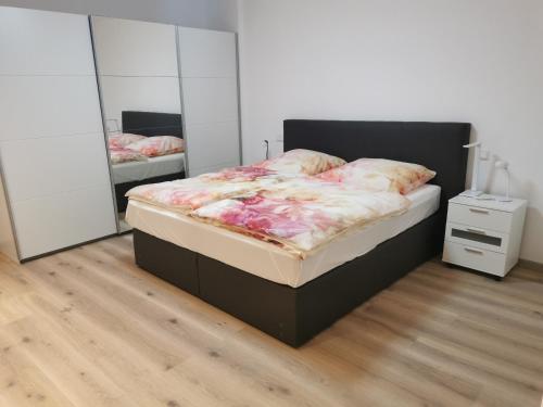 a bedroom with a bed and two mirrors at Ferienwohnung Northeim City in Northeim