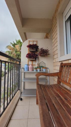 a porch with a wooden bench on a balcony at Apartamento 50m2 Hospital Einstein Morumbi in Sao Paulo