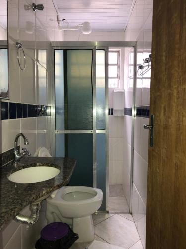uma casa de banho com um WC, um lavatório e um chuveiro em Hotel Pousada Nosso Cantinho em Ubatuba