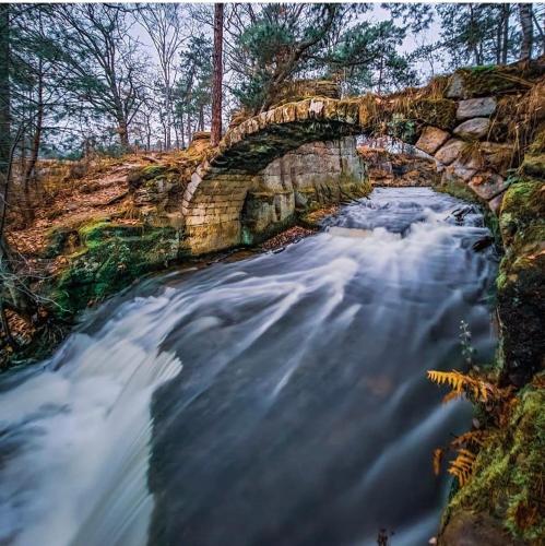 a long exposure photo of a river with a bridge at Vikendovka Korce in Dubá