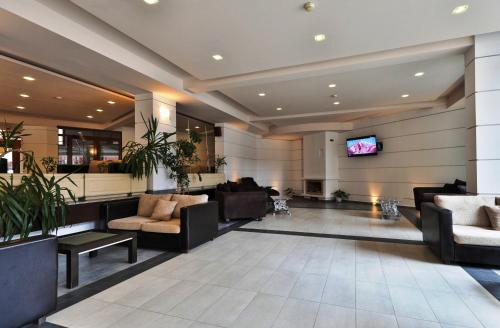 a lobby with couches and a flat screen tv at Bellevue Residence RELAX ZONE in Bansko