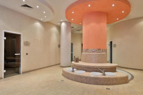 a lobby with a large fountain in the middle of a building at Bellevue Residence RELAX ZONE in Bansko