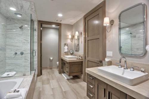 a large bathroom with two sinks and a shower at Stein Eriksen Residences in Park City