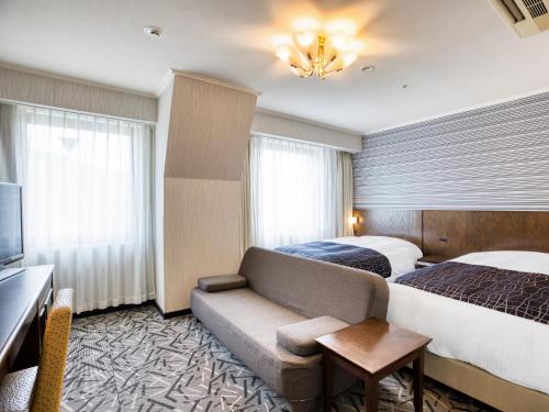 Llit o llits en una habitació de APA Hotel Matsuyamajo-Nishi