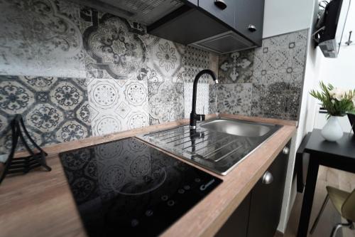 a kitchen with a sink and a stove at IL CASALE POMPEIANO in Pompei