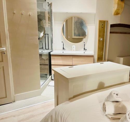 a bathroom with a bed and a shower and a sink at l'Appartement Grand Théatre in Bordeaux