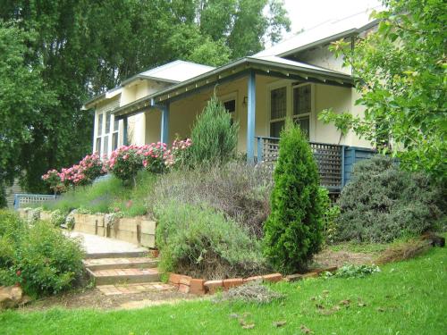 a house with a garden in front of it at Summerhill Farm B&B in Main Ridge