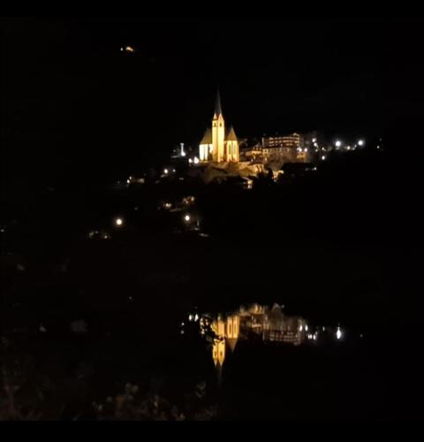 a view of a city at night with a building at Hotel - Restaurant - Sonnblick in Heiligenblut