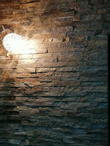 a brick wall with a light on it at Tara Bozic Apartmani in Kaludjerske Bare