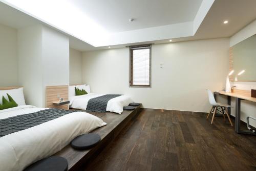 Postel nebo postele na pokoji v ubytování Metro Hotel Myeongdong