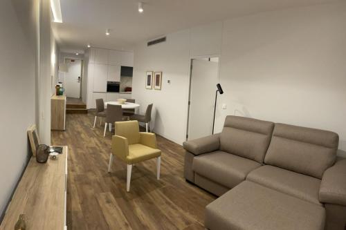 a living room with a couch and a table at Hortas Residence 13 in Funchal