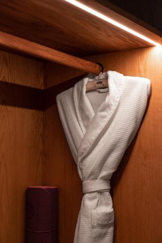 a closet with a tie hanging on a shelf at Casa Antonieta in Oaxaca City