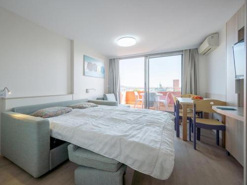 a bedroom with a large bed and a dining room at Les jardins de la Côte d'azur in Saint-Mandrier-sur-Mer