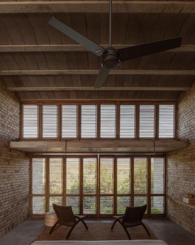 a room with two chairs and a ceiling fan at Terrestre, a Member of Design Hotels in Puerto Escondido