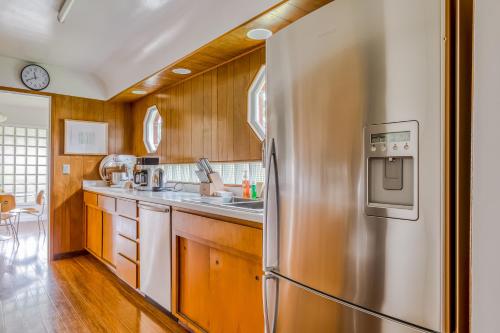 a kitchen with a stainless steel refrigerator and wooden cabinets at Lake Oswego Mid-Century in Lake Oswego