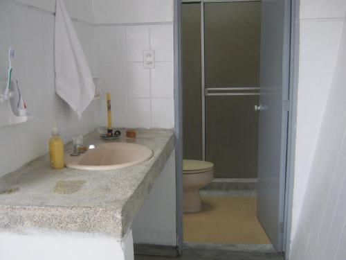 a bathroom with a sink and a shower with a toilet at ANGIE`s HOUSE in Manizales