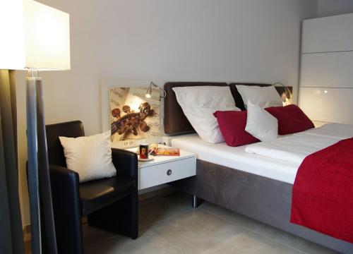 a bedroom with a bed with a desk and a chair at Ferienwohnung Salzburg in Bad Reichenhall