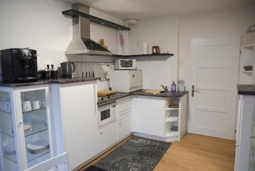 a kitchen with white cabinets and a stove at Ferienhaus Lebenskraft in Pfaffetschlag