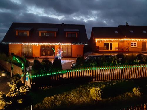a house with christmas lights on the front of it at Panorama in Trakai