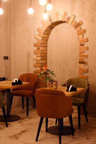 a dining room with two tables and a brick wall at The Golden Pera's Hotel & Spa in Istanbul