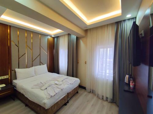 A bed or beds in a room at The Golden Pera's Hotel & Spa