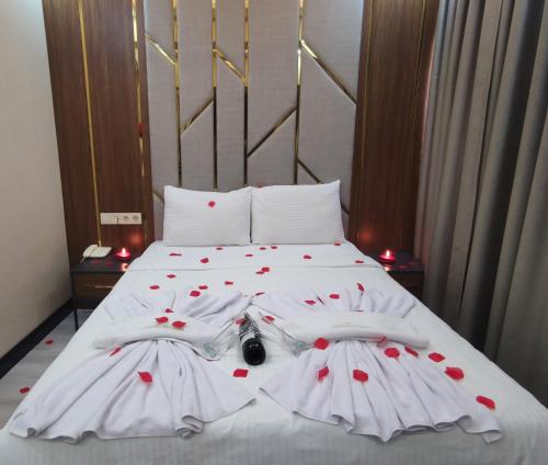 a white bed with red hearts on it at The Golden Pera's Hotel & Spa in Istanbul